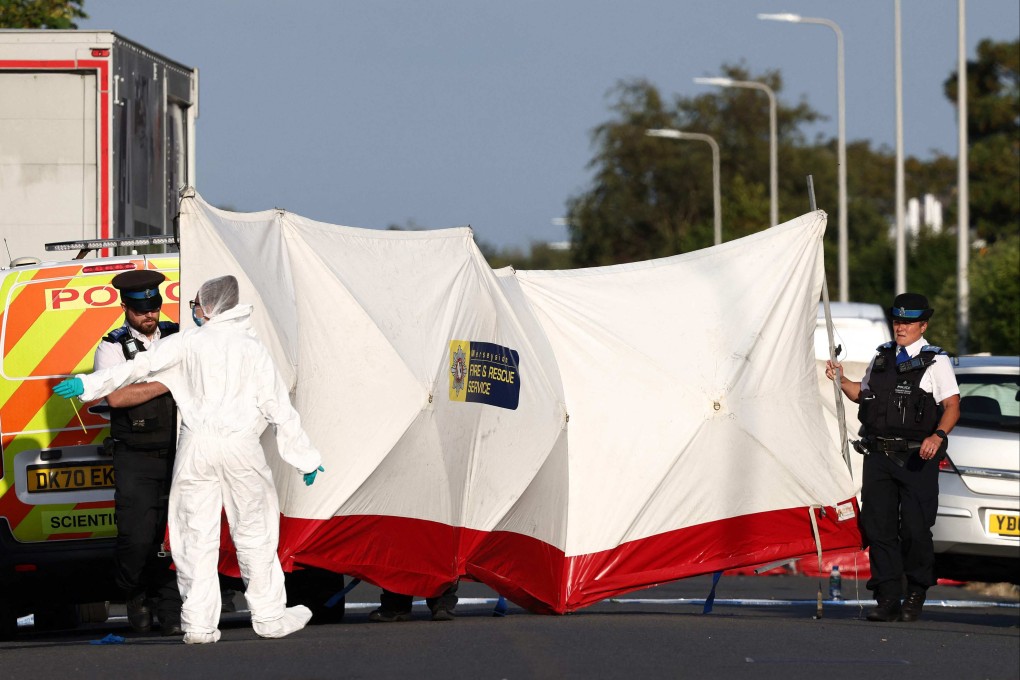 Police officers and forensic personnel at the scene following the knife attack. Photo: AFP