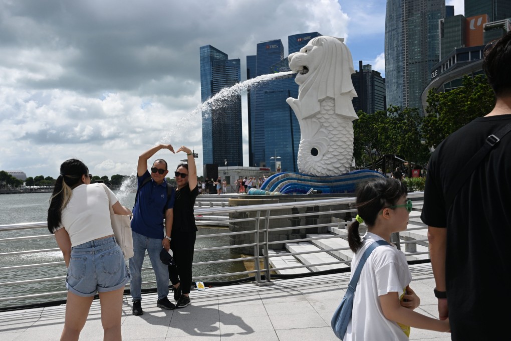Visitors enjoying the view at the Merlion statue in Singapore. The city state has been very welcoming of foreigners, but some segments in society, fearing threats to their lifestyles and livelihoods, are starting to resist. Photo: Xinhua