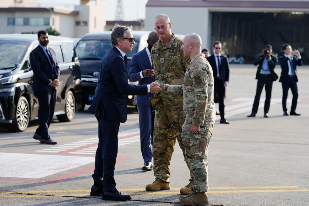 US Secretary of State Antony Blinken (left) greets US Air Force personnel before boarding his plane to depart Yokota Air Base in Fussa, on the outskirts of Tokyo, on Monday. Photo: AFP