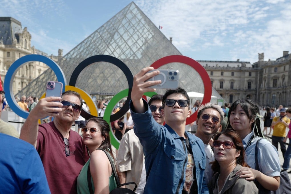Visitors in front of the Louvre Pyramid. The number of travellers to Paris from China and Japan showed some of the biggest increases globally during the period covering the Olympics. Photo: AFP
