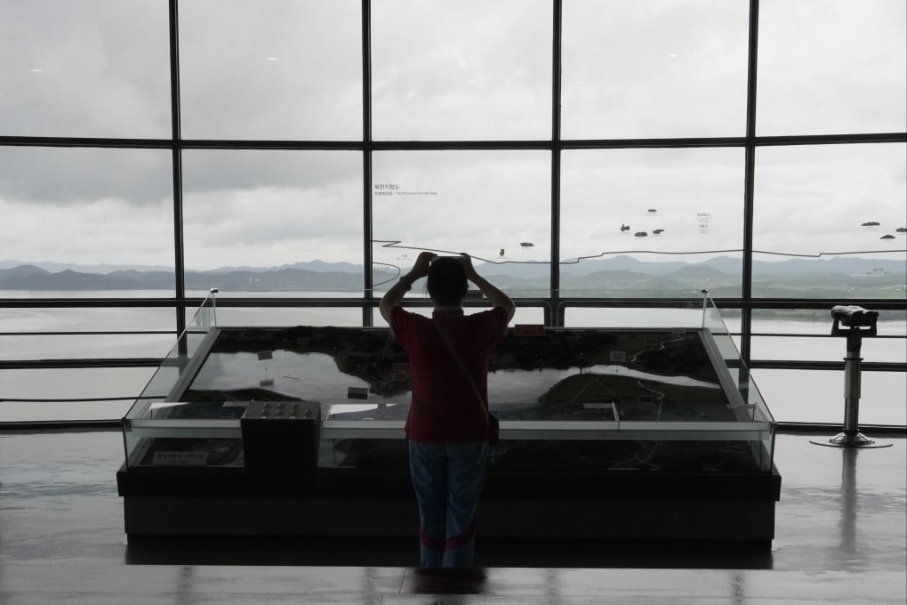 A visitor takes photos toward the North Korea side from the Unification Observation Post in Paju, South Korea. Photo: AP