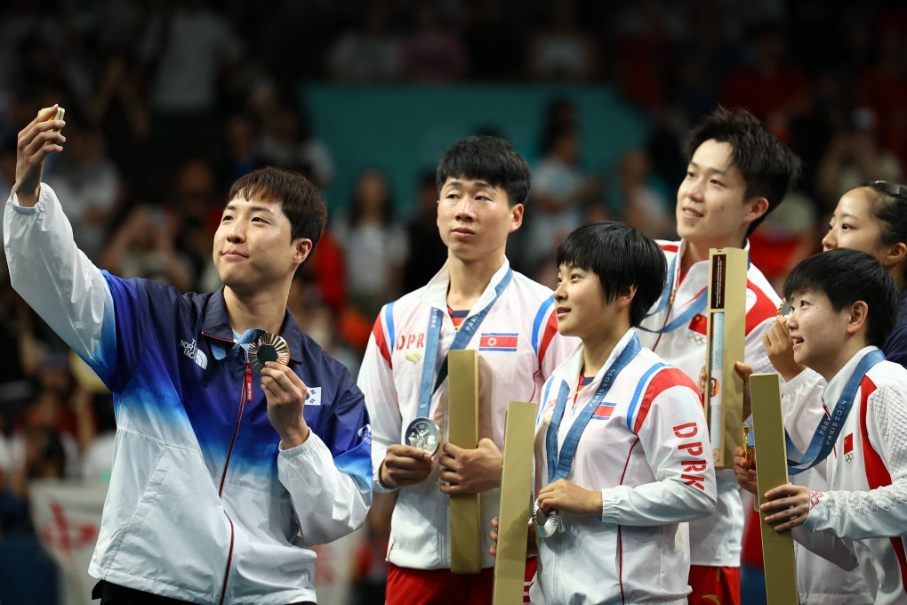 From left, South Korea’s Lim Jong-hoon with North Korea’s Ri Jong-sik and Kim  Kum-yong, China’s Wang Chuqin and Sun Yingsha, and teammate Shin Yu-bin. Photo: Reuters
