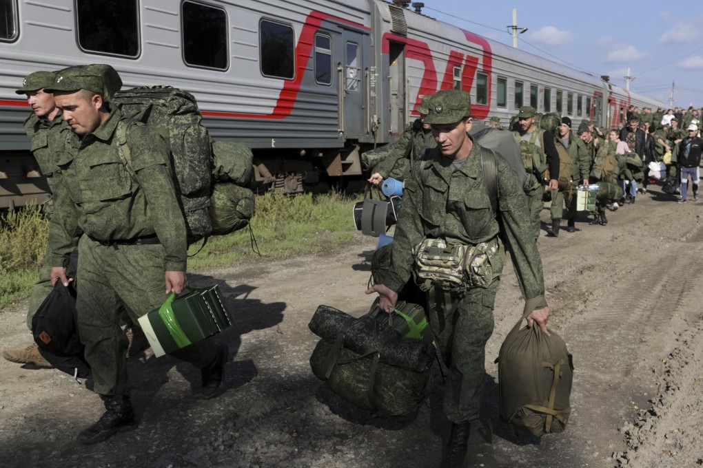 Russian recruits walk to take a train at a railway station in the Volgograd region of Russia, on September 29, 2022. President Putin more than doubled payments to those signing up for Ukraine war. Photo: AP