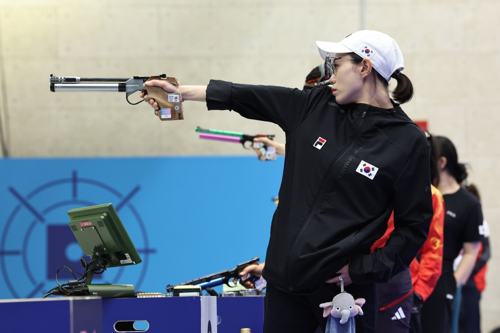 South Korea’s Kim Ye-ji competing in the 10m air pistol women’s final while carrying a stuffed elephant that reportedly belongs to her daughter. Photo: Xinhua