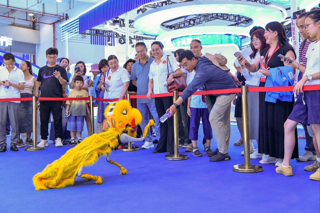 Visitors interact with a robotic dragon during the 8th China-South Asia Expo in Kunming, China, on July 25. Beijing hopes that China’s technology and services of the future sectors will take over from manufacturing and property as the focus of the country’s economy. Photo: Xinhua