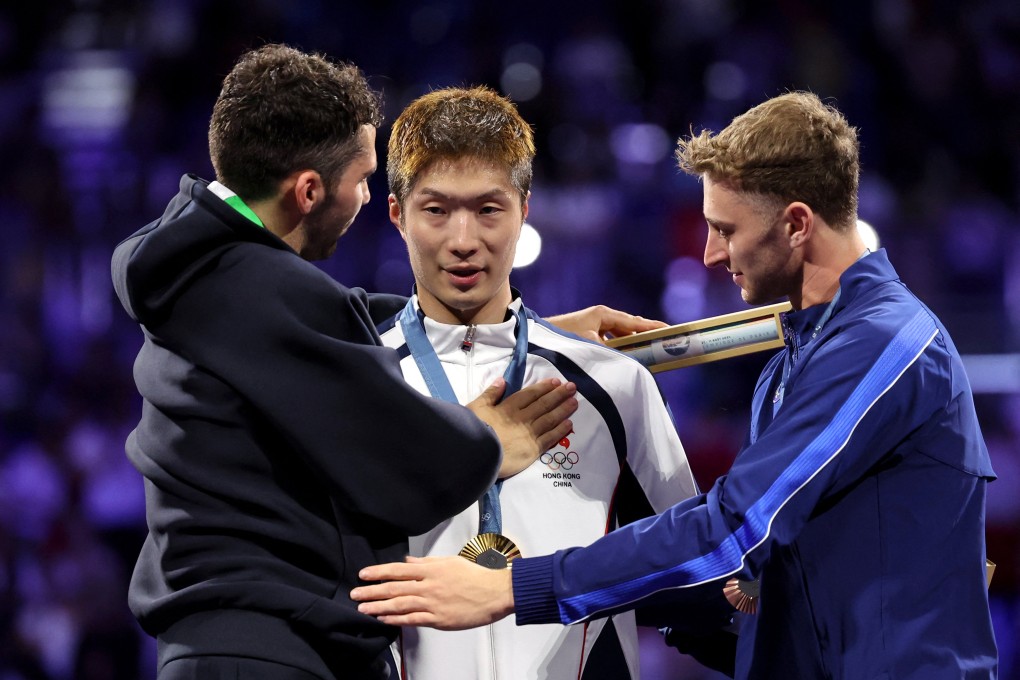 Gold medalist Ka Long Cheung of Hong Kong celebrates with silver medalist Filippo Macchi of Italy and bronze medalist Nick Itkin of United States after winning. Photo: Reuters