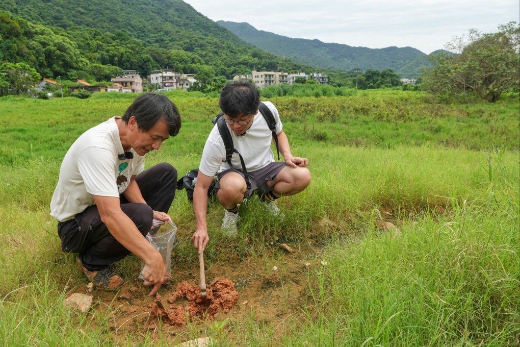 Yip Tsz-lam (left) of Kadoorie Farm and Botanic Garden and Chan Kim-ching of Liber Research Community check a site’s viability as farmland. Photo: Elson Li