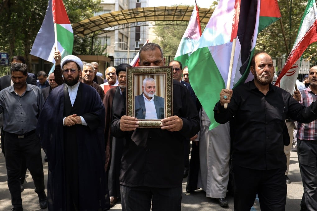 Protesters carry a portrait of late Hamas political leader Ismail Haniyeh at Tehran University on Wednesday. Photo: EPA-EFE