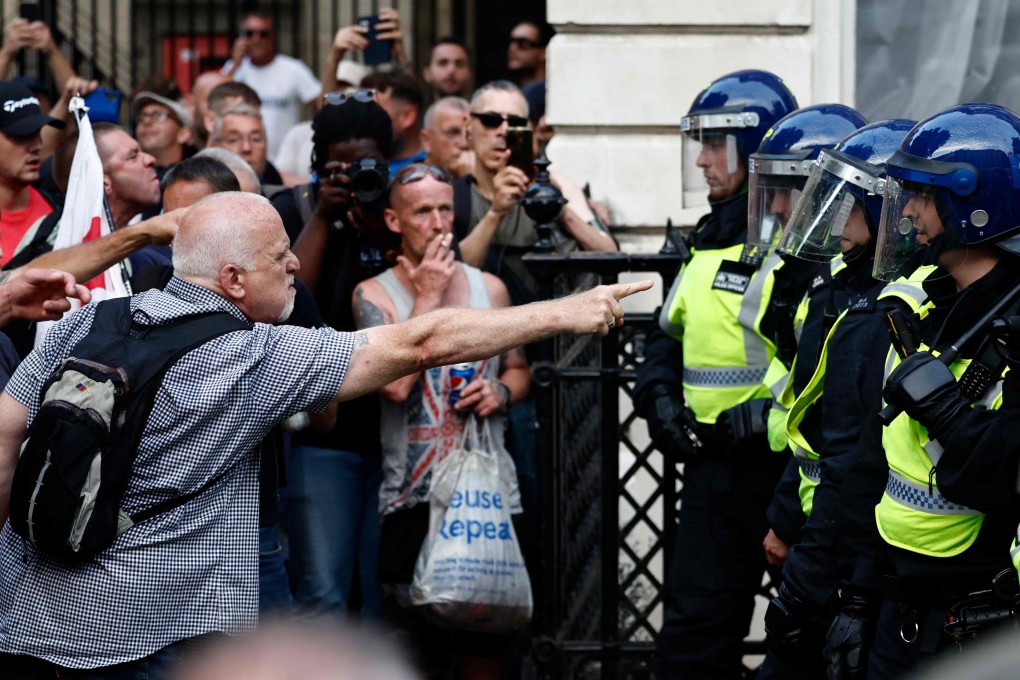 Protestors remonstrate with police during the ‘Enough is Enough’ demonstration outside the entrance to 10 Downing Street in London on Wednesday, held in reaction the government’s response to the fatal stabbings of children in Southport. Photo: AFP