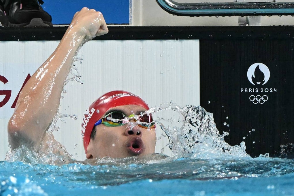 China’s Pan Zhanle raises a fist after breaking the world record on his way to gold. Photo: AFP