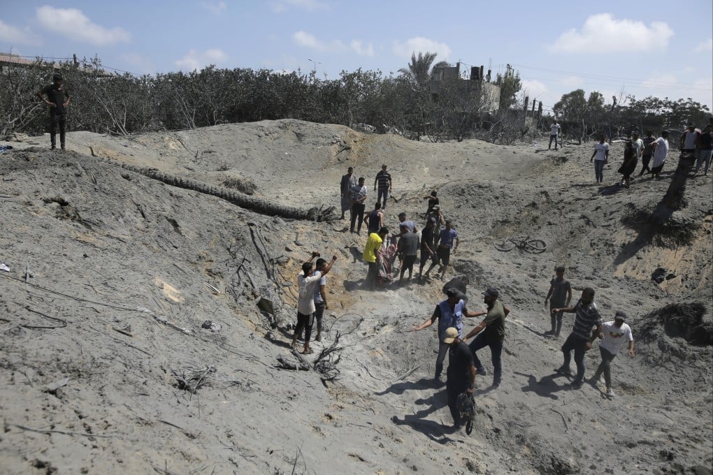 Palestinians search for bodies and survivors in a site hit by an Israeli bombardment on Khan Younis on July 13. Photo: AP