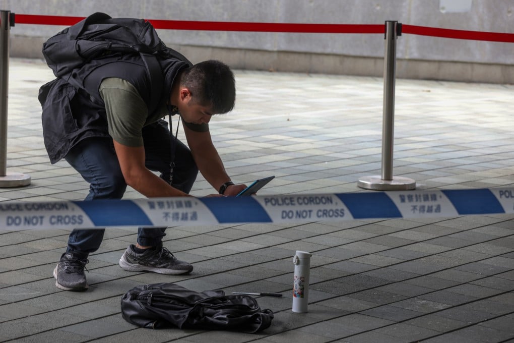 A police officer photographs the knife used by the teenager in the attack against the security guard outside government headquarters. Photo: Yik Yeung-man