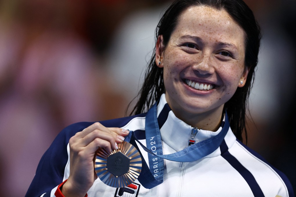 Hong Kong swimmer Siobhan Haughey celebrates on the podium after taking the 200m freestyle bronze medal at the Paris Olympic Games. Photo: Reuters