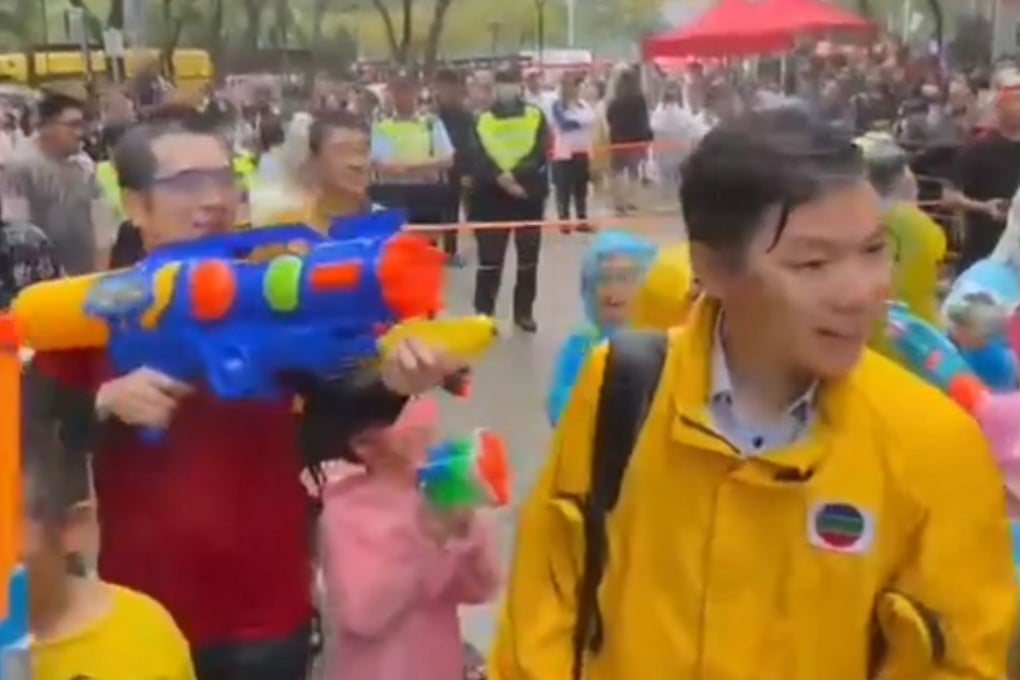 A video screengrab shows TVB reporter Timothy Li (right) being splashed with water.in Kowloon City. Photo: Handout