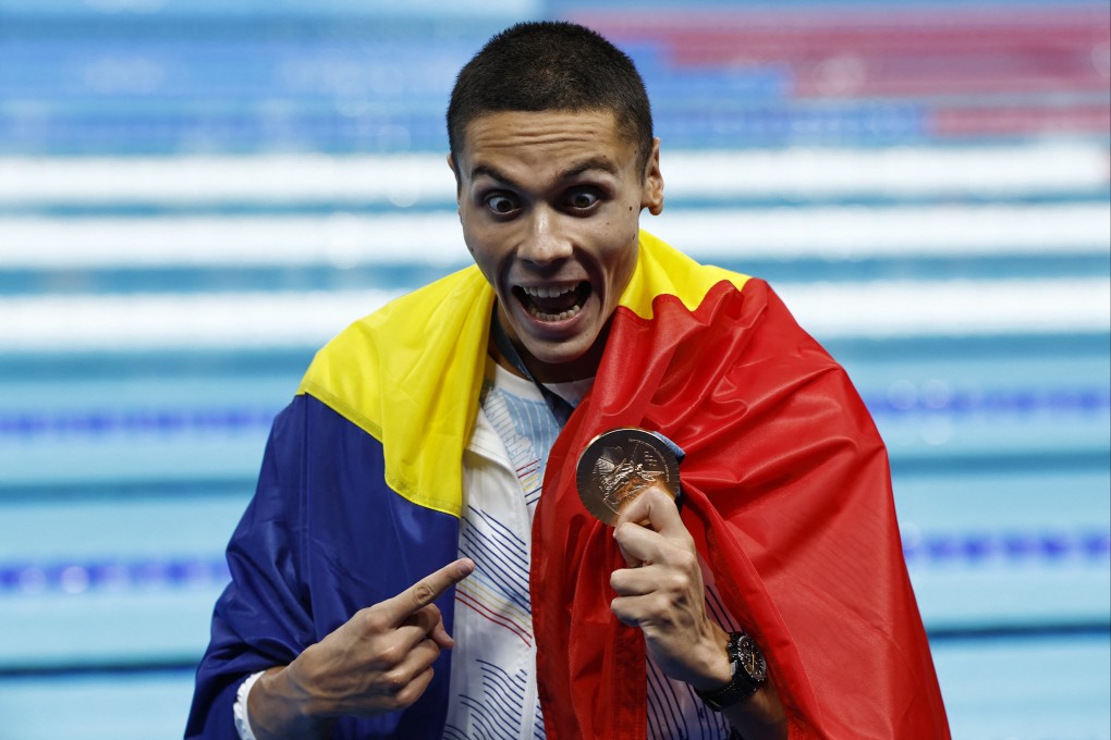 David Popovici with the bronze medal he won at the men’s 100m freestyle. Photo: Photo: Reuters