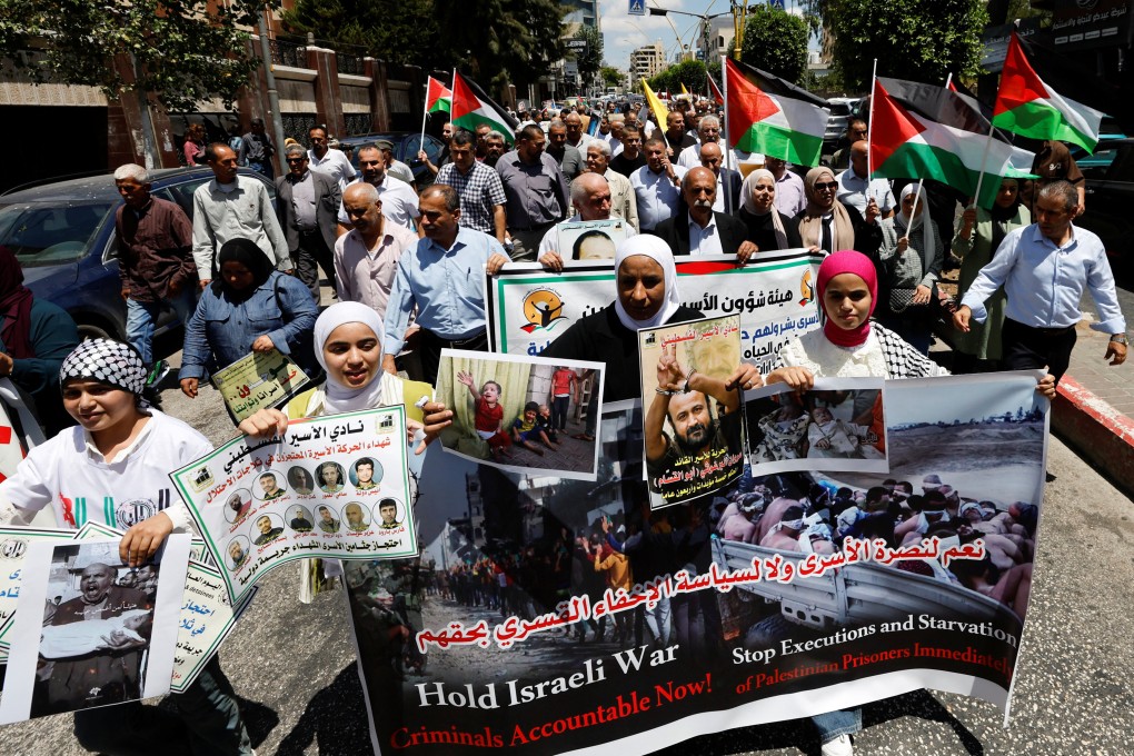 Palestinians hold placards during a protest in solidarity with Gaza and Palestinian prisoners in the Israeli jails, in Hebron in the Israeli-occupied West Bank on Saturday. Photo: Reuters