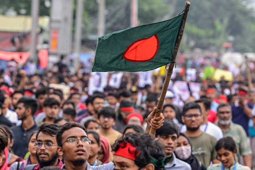 A protester waves the Bangladeshi flag during a protest in Dhaka on Saturday. Bangladesh’s Prime Minister Sheikh Hasina’s government weathered worsening backlash following a deadly police crackdown on protesters. Photo: AFP