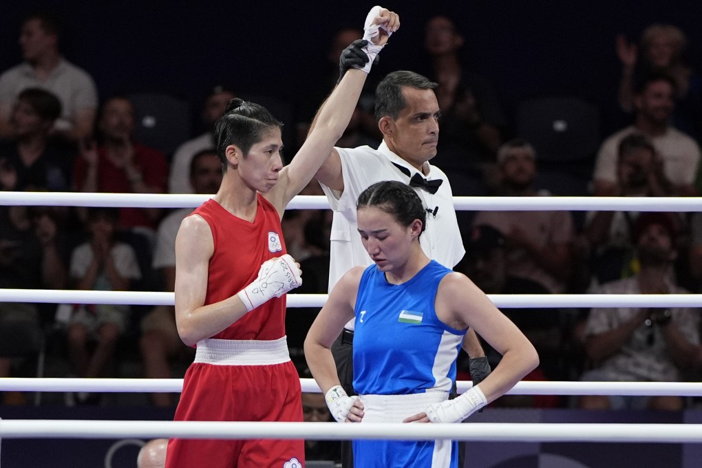 Chinese Taipei’s Lin Yu-ting (left) declared winner against Uzbekistan’s Sitora Turdibekova in their women’s 57kg preliminary match in Paris. Photo: AP