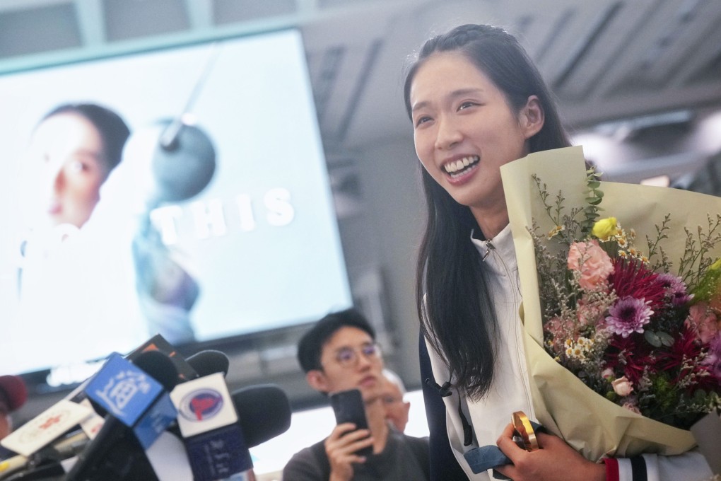 Olympic gold medalist Vivian Kong meets the press at Hong Kong International Airport after returning from Paris. Photo: Elson Li