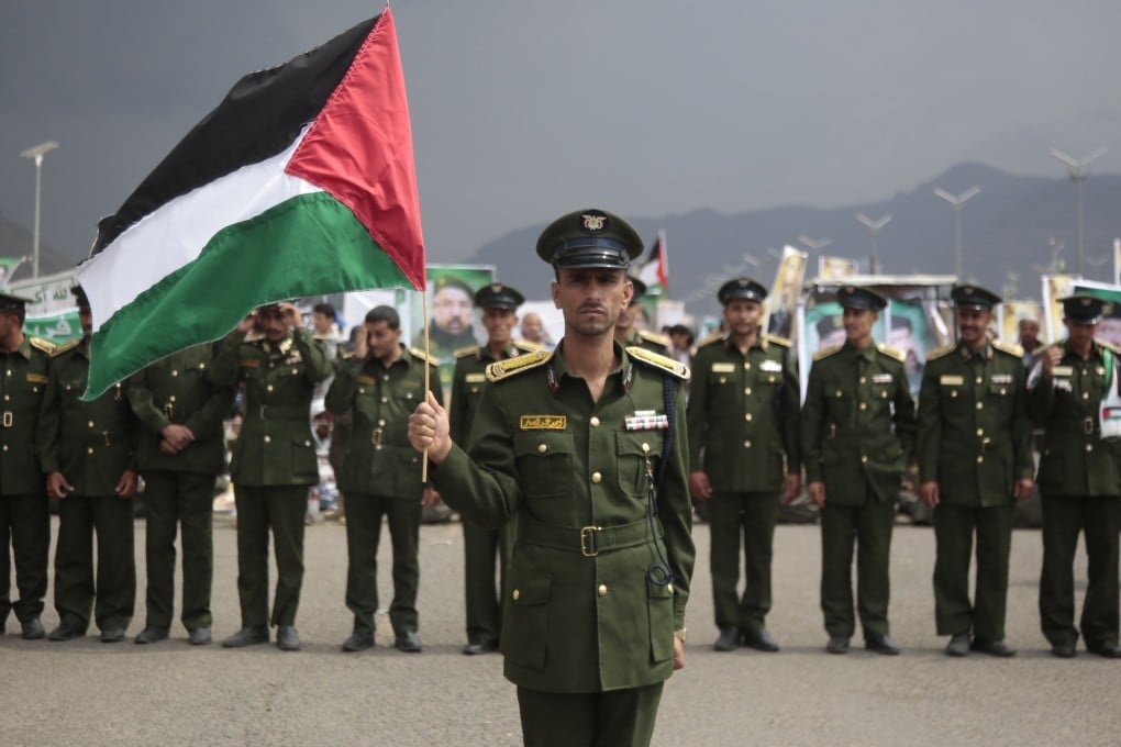 A Yemeni soldier holds a Palestinian flag during a protest of Houthi supporters following the death of Hamas and Hezbollah leaders, in Sana’a, Yemen, on Friday. Photo: EPA-EFE