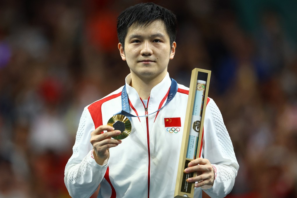 China’s Fan Zhendong poses with his gold medal. Photo: Reuters