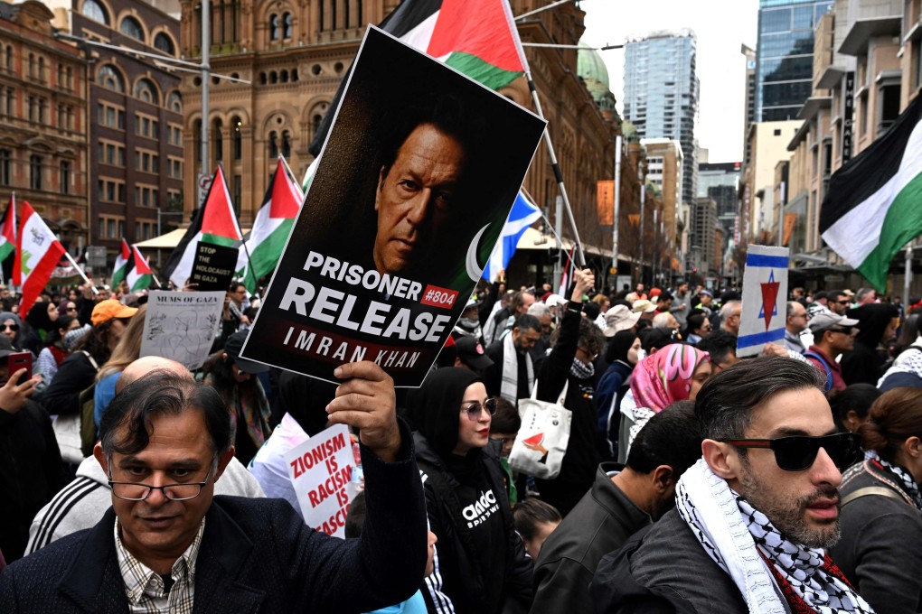 Supporters of Pakistan’s jailed former premier Imran Khan, pictured on placard, join a pro-Palestinian demonstration on Sunday. Photo: AFP