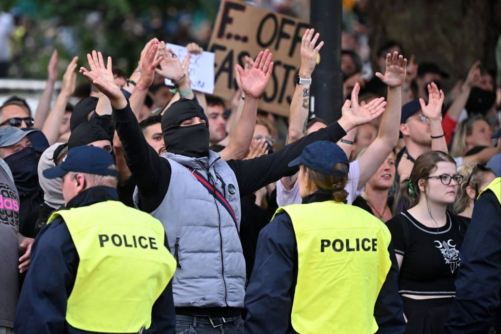 Anti-fascism protesters gesture at people who had gathered for the ‘Enough is Enough’ demonstration called by far-right activists in Bristol on Saturday. Photo: AFP