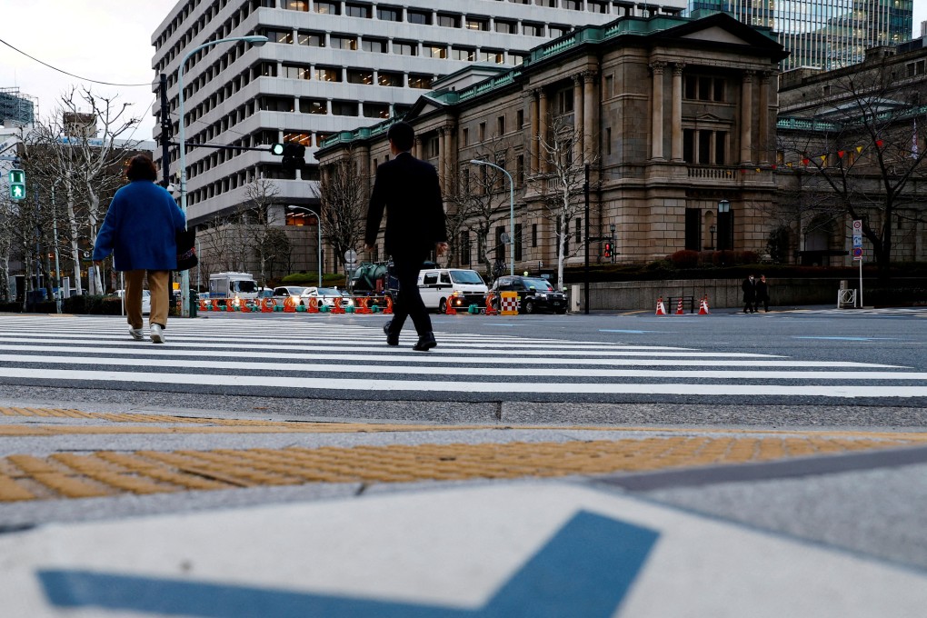People walk in front of the Bank of Japan building in Tokyo, Japan January 23, 2024. Photo: Reuters
