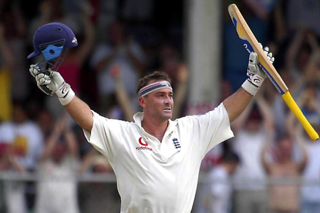 England’s batsman Graham Thorpe raises his bat and helmet in celebration after scoring an unbeaten 119 on the second day of the third Test against West Indies at Kensington Oval, Barbados, April 2, 2004. Photo: AP