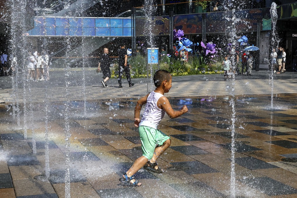 A boy keeps cool on a hot day. A Hong Kong author is using jingles to educate children and remind them to take precautions during heatwaves, and will be creating jingles to remind them how to act in other natural disasters. Photo: Reuters