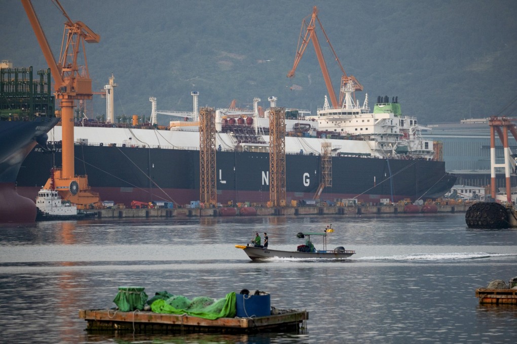 A fishing boat sails past liquefied natural gas tankers under construction at the Daewoo Shipbuilding & Marine Engineering shipyard in Geoje, South Korea. Photo: Bloomberg