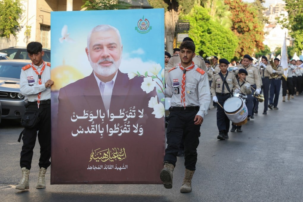 Members of Imam al-Mahdi scouts carry a picture depicting late Hamas leader Ismail Haniyeh during a protest condemning his killing, in Sidon, Lebanon, on Monday. Photo: Reuters
