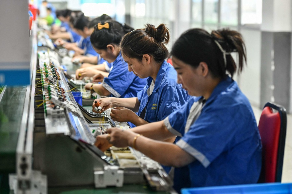 A worker produces silk products at a factory of a silk company in southeastern China’s Chongqing municipality. Photo: AFP