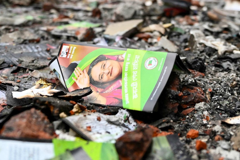 A burnt Awami League party flyer is pictured in Dhaka on August 6, after former prime minister Sheikh Hasina fled the country. Photo: AFP