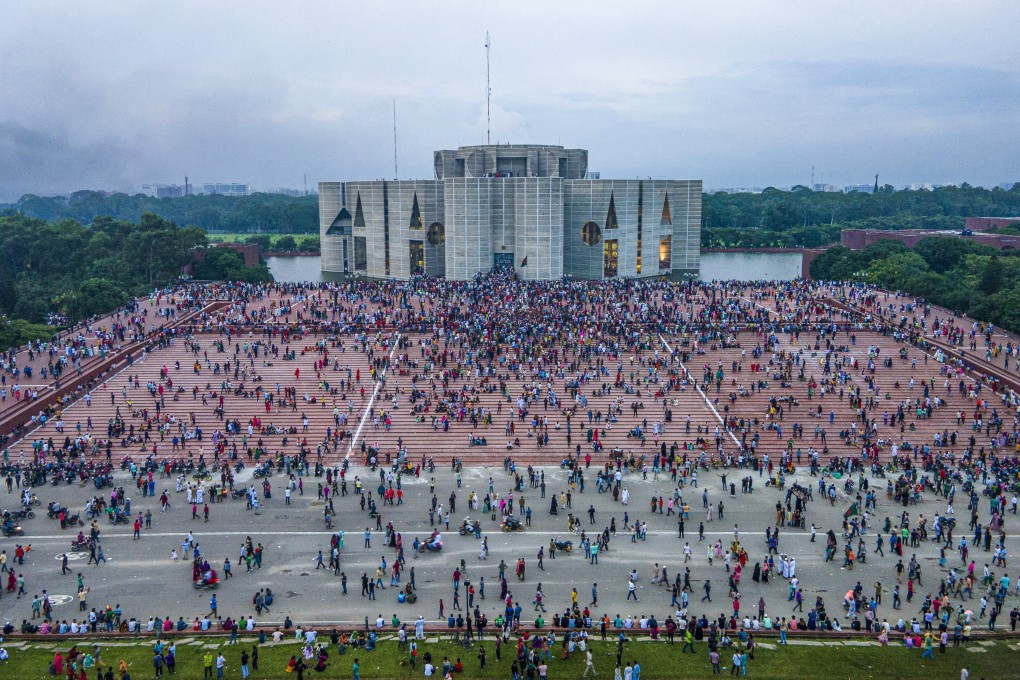 Crowds gather at the Bangladesh Parliament House in Dhaka on Monday. In an address to the nation, Chief of Army Staff General Waker-Uz-Zaman announced that Prime Minister Sheikh Hasina had resigned after weeks of unrest and an interim government would be formed to run the country. Photo: EPA-EFE