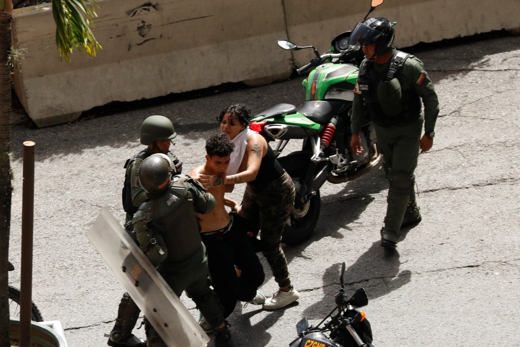 Bolivarian National Guard detain demonstrators during protests in Caracas, Venezuela. Photo: Reuters