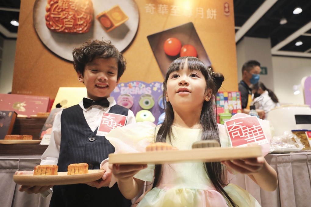 Two young promoters offer mooncake samples at a preview tour of the Hong Kong Food Expo. Photo: Xiaomei Chen