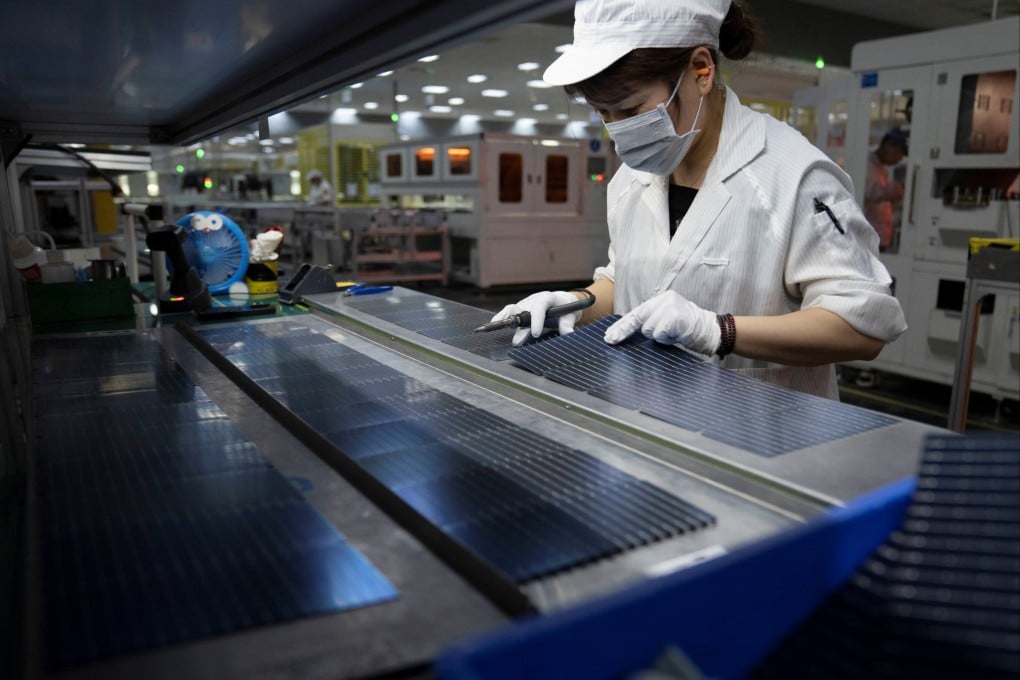 An employee works on the production line for solar panels at GCL Technology’s factory in Hefei, Anhui province. The company is testing out a new solar cell technology. Photo: Reuters
