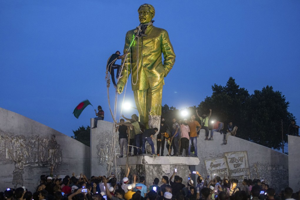 Protesters try to demolish a large statue of Sheikh Mujibur Rahman, father of Bangladesh’s former prime minister Sheikh Hasina, after she resigned in Dhaka, Bangladesh, on August 5. Photo: AP