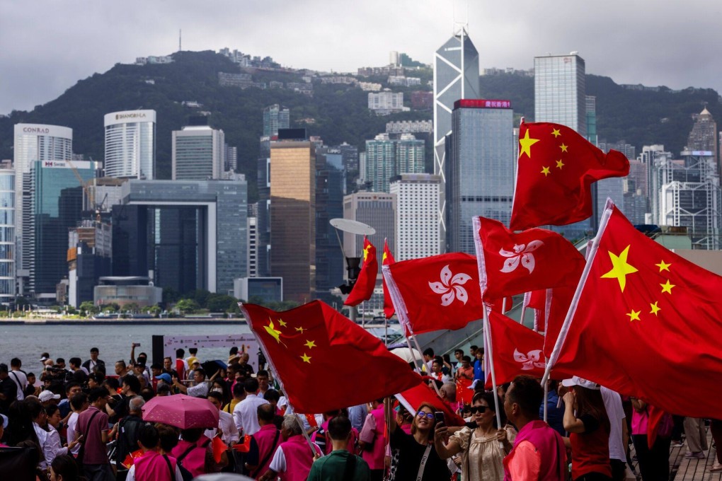 People wave the Chinese national and Hong Kong special administrative region flags during an event celebrating the 27th anniversary of Hong Kong’s return to Chinese rule on July 1. Photo: Bloomberg