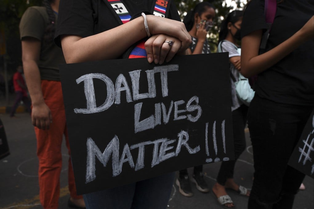 A protester holds a placard reading during a 2020 protest against the alleged gang-rape and murder of a woman in Uttar Pradesh state. Photo: AFP