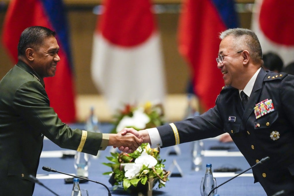 Philippine military chief General Romeo Brawner Jnr (left) shakes hands with Japan Self-Defense Force Chief of Staff General Yoshihide Yoshida as they arrive before meetings with Philippine and Japanese foreign and defence ministers at a hotel in Taguig, Philippines, on July 8. Japan and the Philippines have signed a defense pact allowing their troops to enter each other’s country. Photo: AP