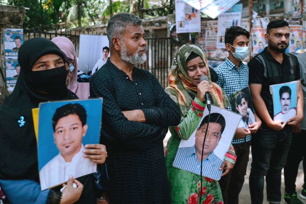 Holding the photo of her father, an alleged victim of enforced disappearance in Bangladesh, a girl breaks down in a rally in Dhaka on June 24, 2023. Photo: Abdur Rajjak
