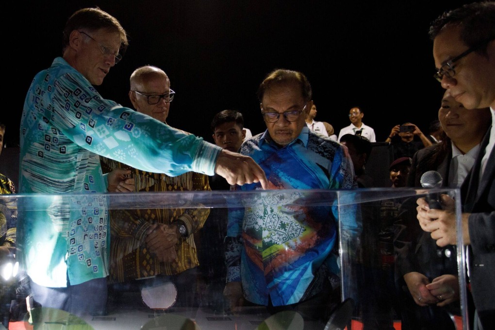 Infineon CEO Jochen Hanebeck (left) and Malaysia’s Prime Minister Anwar Ibrahim (centre) during the opening of the company’s new plant in Kulim on Thursday. Photo: Bloomberg