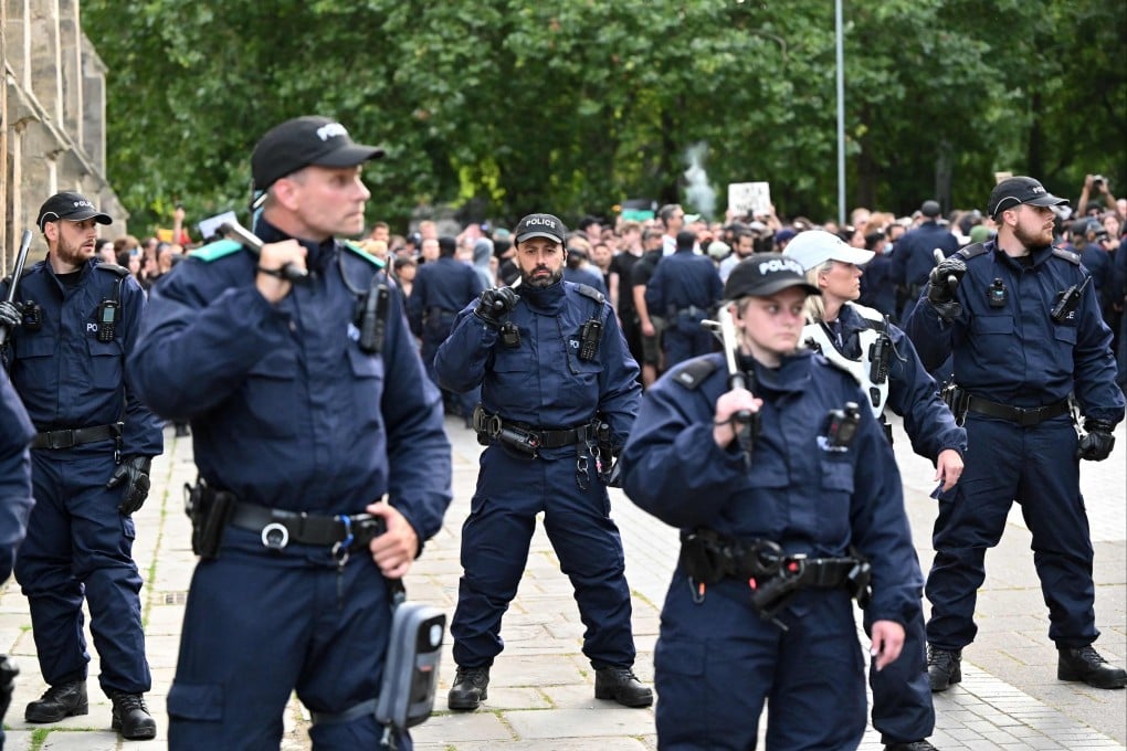 Police stand guard at a demonstration called by far-right activists in Bristol on Saturday. Photo: AFP