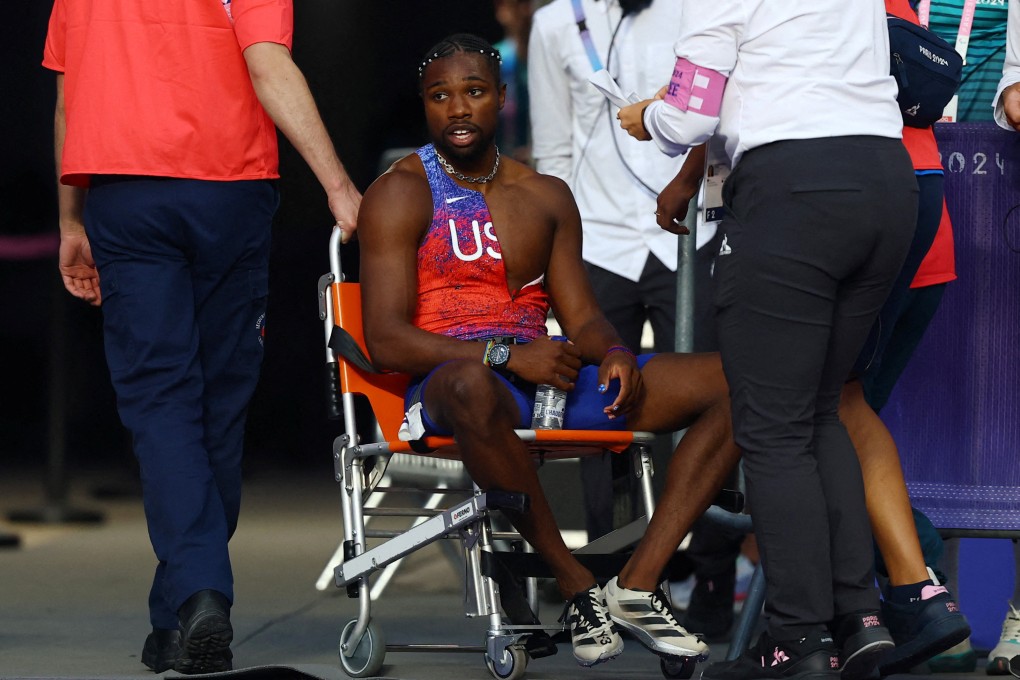 Noah Lyles (far left) receives care from medical staff following the men’s Olympic 200m final. Photo: Reuters