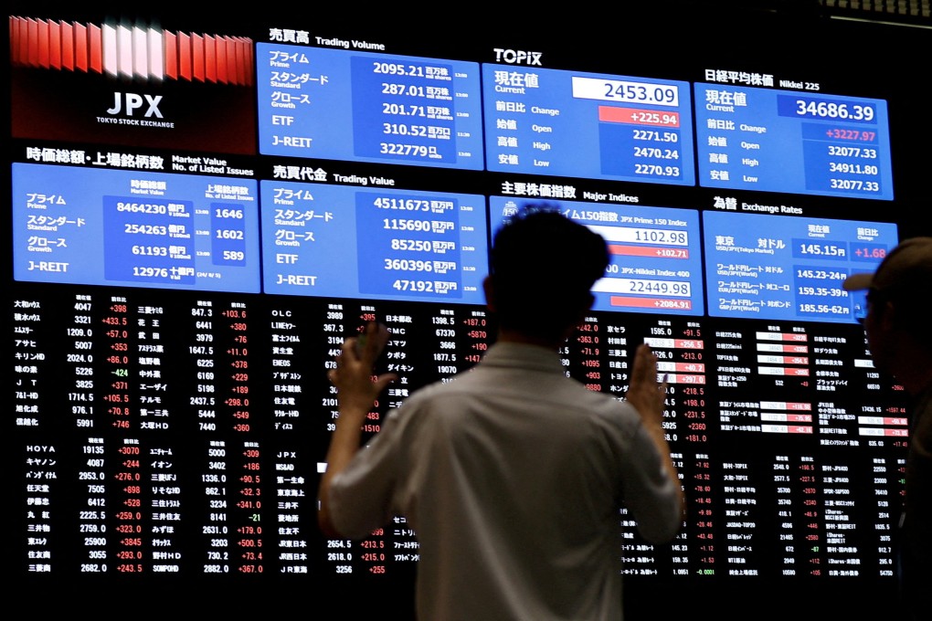 People look at the stock quotation board at the Tokyo Stock Exchange on August 6. After suffering its worst day in percentage terms since 1987 on Monday, Japan’s Nikkei 225 notched one of its best days and rose more than 10 per cent on Tuesday, recovering most of the ground lost. Photo: Reuters