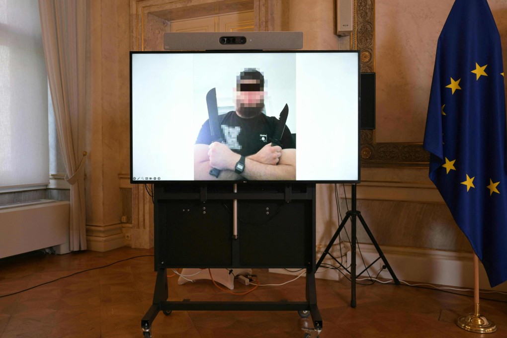 A screen displays a photo of a man arrested in connection with an Islamist attack plot in Vienna, Austria. Photo: AFP