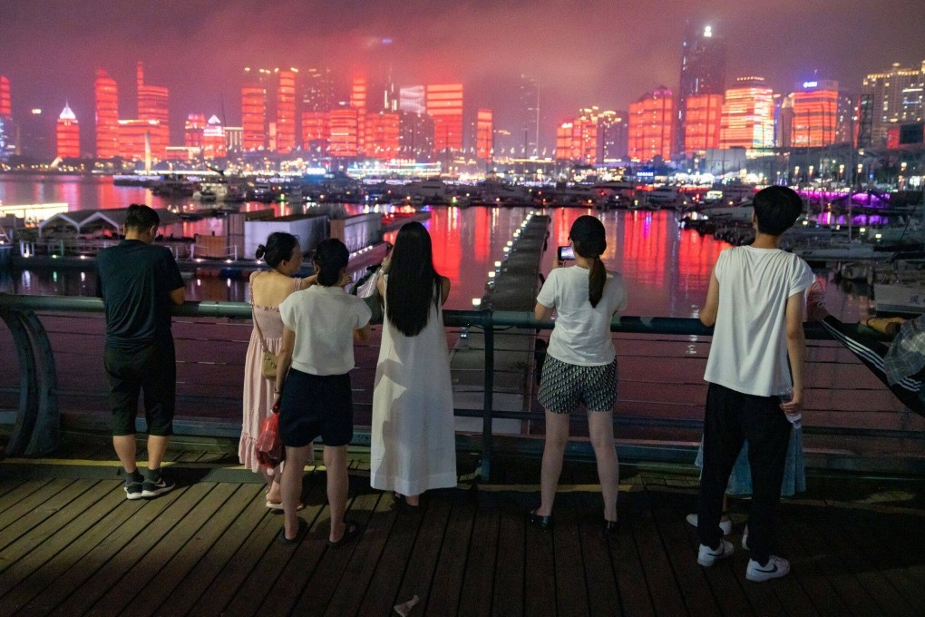 Visitors watch a light show in Qingdao, Shandong province, China. Photo: Bloomberg