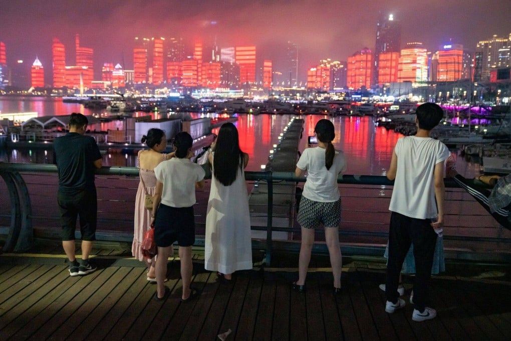 Visitors watch a light show in Qingdao, Shandong province, China. Photo: Bloomberg